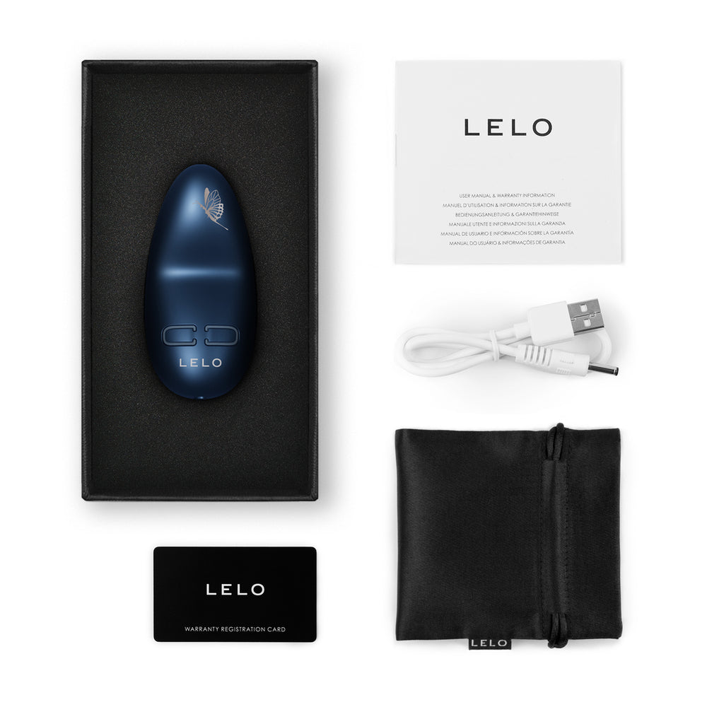 LELO clitoral vibrator in navy blue with packaging, USB charging cable, satin pouch, and instruction manual – luxury external stimulator set
