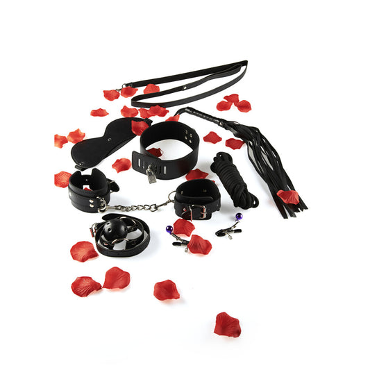 Black BDSM bondage kit with cuffs, collar, gag, leash, flogger, rope, and nipple clamps, styled with red rose petals on a white background – perfect for beginners exploring bondage play